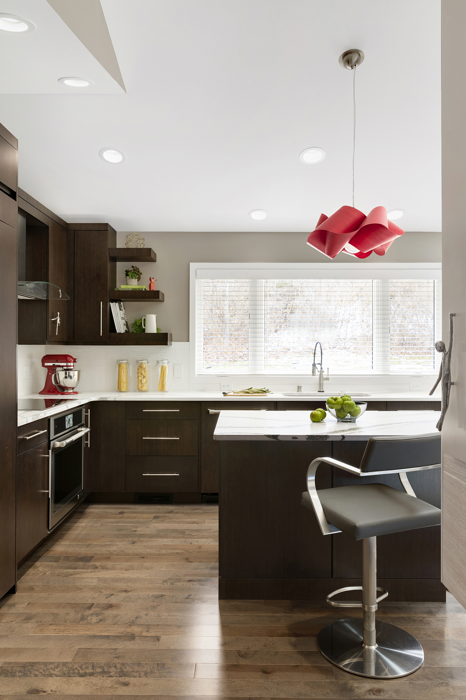 Modern kitchen remodel with dark wood cabinets and accent lighting